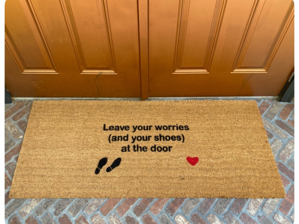 doublewide doormat reading "leave your worries and your shoes at the door