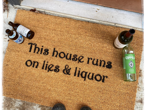 This house runs on lies & liquor™ doormat
