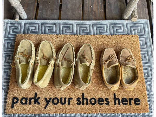 Park your shoes here, funny doormat with 3 pairs of slippers on it