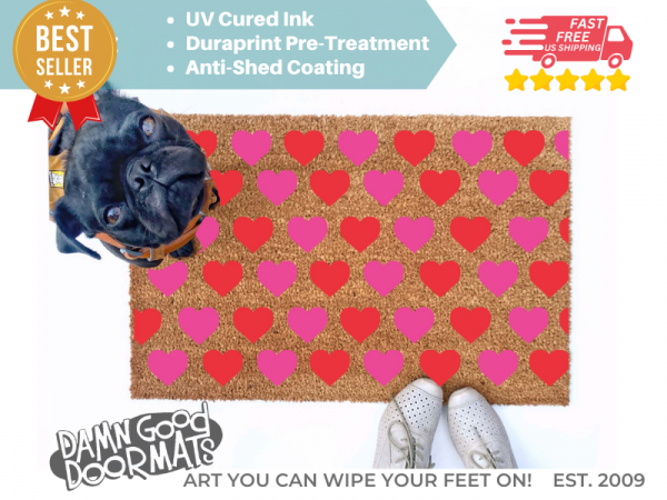 cute pink pattern hearts Valentine's Day doormat shown with a little black pug
