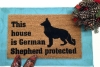 This house is German Shepard protected dog door mat
