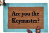 outdoor coir doormat "are you the gatekeeper" on blue layering rug