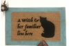 a witch and her familiar live here black cat halloween gothic home doormat
