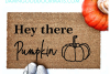 lifestyle photo Hey there Pumpkin coir outdoor Doormat with cute white shoes