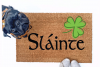 Failte shamrock St Patrick's day coir doormat with a little black pug