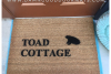 picture of coir outdoor doormat reading toad cottage with a silhouette of a toad
