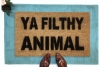 Ya Filthy Animal Home Alone doormat on top of a blue layering rug