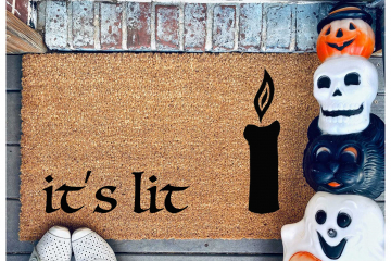 hocus pocus doormat reading it's lit with the black flame candle