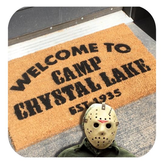 Welcome to Camp Crystal Lake Friday the 13th coir doormat at spooky doorway with a fawn pug and witches broom
