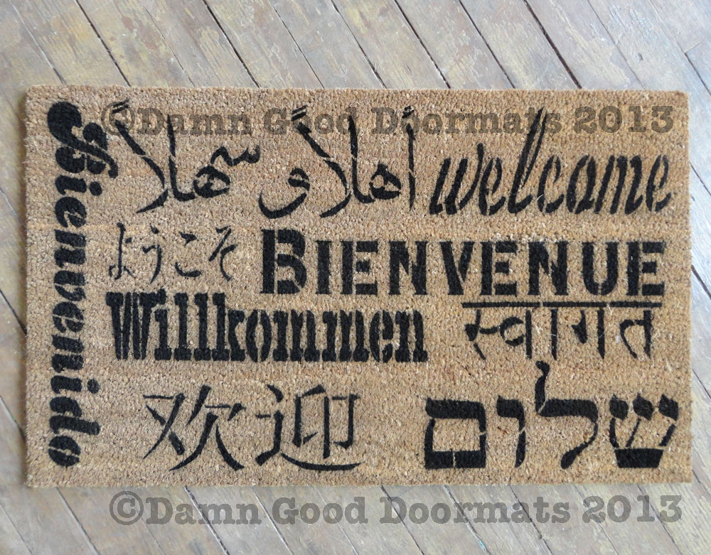 Welcome in all languages doormat, English, Spanish, French, German, Arabic, Hebrew, Chinese, Japanese, Korean, and Hindi