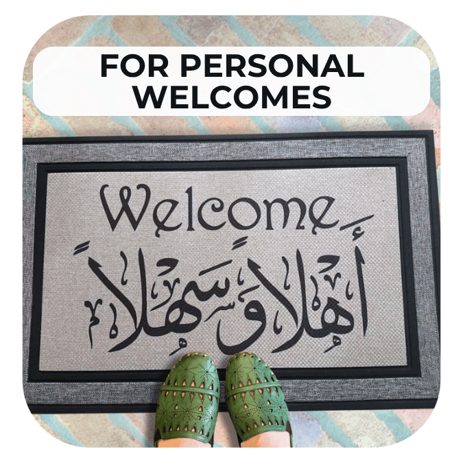 Arabic and English bilingual welcome mat on a brick patio