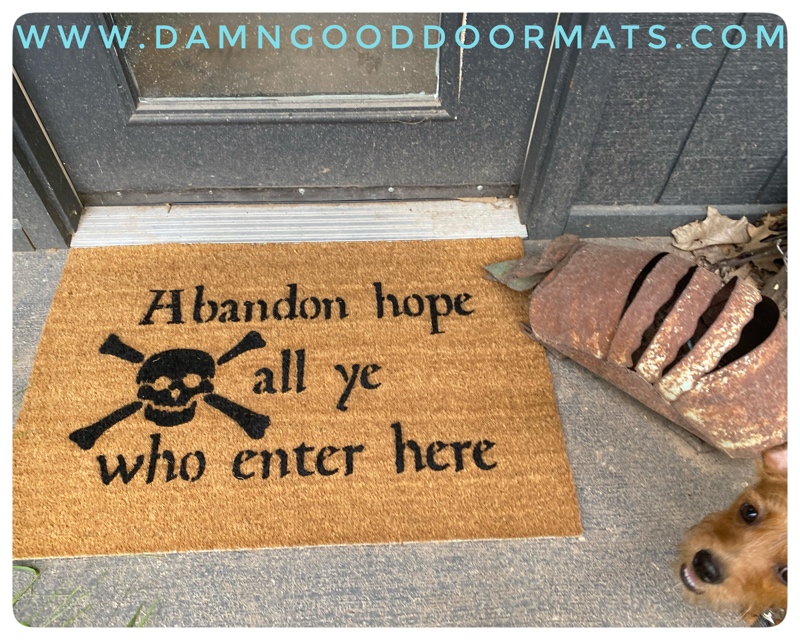 Dante quote "Abandon hope all ye who enter here" coir doormat on a man cave entryway with a rusty metal armadillo