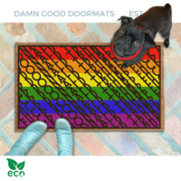 subtle fuck donald trump doormat in abstract contemporary design over gay pride rainbow flag. A pair of feet wearing baby blue boots stands with a black pug dog sitting on the floor next to them. 