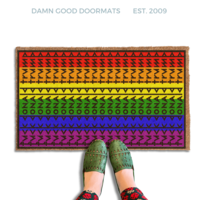 subtle fuck donald trump doormat in abstract contemporary design over the gay pride rainbow flag. 