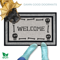 a black pug dog in a Halloween gold dragon costume welcome mat with the word "WELCOME", and a pair of feet wearing Smurf blue boots