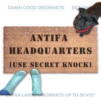 ANTIFA HEADQUARTERS doormat pictured with a little black pug looking up at someone in Smurf blue boots