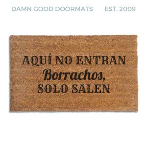Coir doormat printed with Aquí No Entran Borrachos, Solo Salen in black cantina-style and script lettering