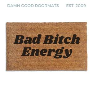 Coir doormat printed with Bad Bitch Energy in bold black italic slab lettering