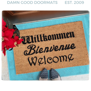 Sustainable coir welcome doormat printed with Willkommen Bienvenue Welcome in black lettering