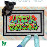 a pair of smurfy blue boots standing on a colorful, graffiti-style doormat with the text "LATER FUCKERS" written on it. A small black pug dog is also present in the scene, sitting on top of the doormat.