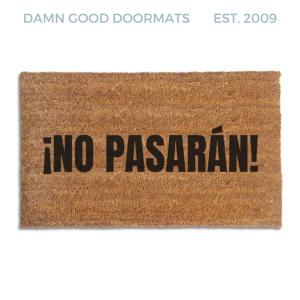 Coir doormat printed with ¡No Pasarán! in tall black condensed capitals