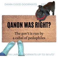 Qanon coir doormat saying "Qanon was right? The government is run by a cabal of pedophiles" . A pair of feet wearing baby blue boots stands with a black pug dog sitting on the floor next to them. 
