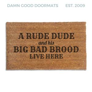 Coir doormat printed with A Rude Dude and His Big Bad Brood Live Here in black western and script lettering