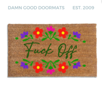 promotional image of a coir doormat reading "fuck off" in cursive with red and purple flowers across the top and bottom