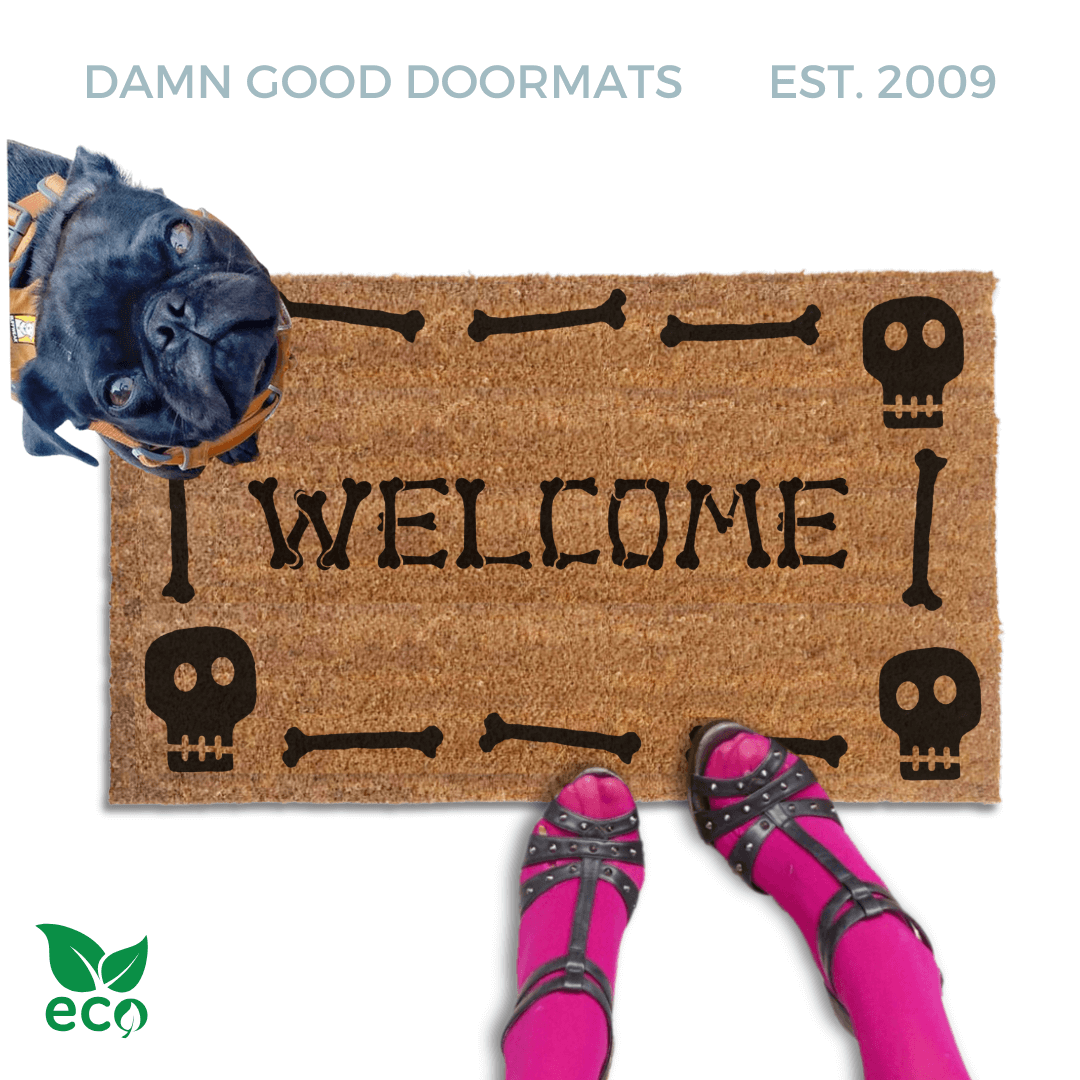 a black pug dog on a Halloween welcome mat with the word "WELCOME", and a pair of feet wearing pink tights and high heels.