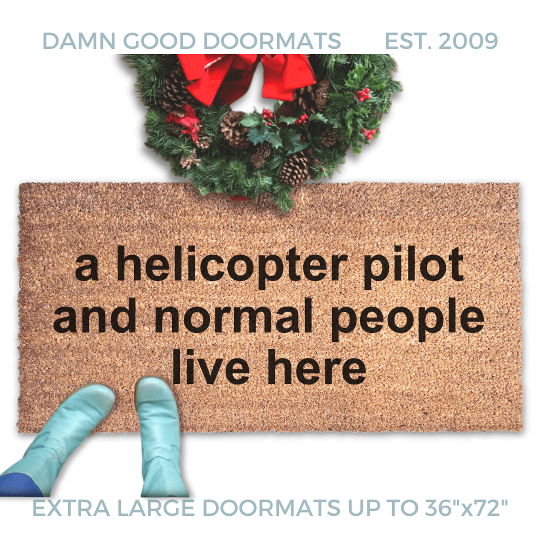 coir doormat with funny saying "a pilot and normal people live here" with a Christmas wreath and a person in Smurf blue boots