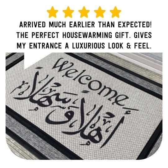 Gray all-weather welcome mat with black English and Arabic Ahlan Wa Sahlan bilingual lettering
