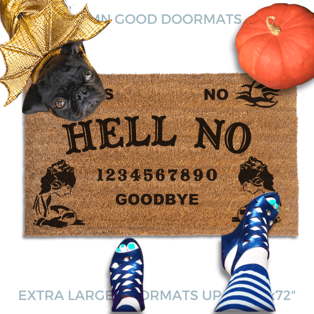 a Halloween welcome mat with a pug in golden dragon wings costume, the word "HELL NO" on it. The mat has a Ouija board design and the numbers "1234656789 GOODBYE" printed on it. The scene includes a person's feet wearing black pointy toed witch boots, an orange pupkin, and the text "DAMN GOOD DOORMATS EST. 2009" is visible.