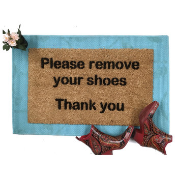 doormat reading Please remove your shoes Thank You on a blue layering rug with p