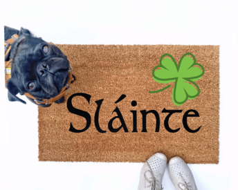 Failte shamrock St Patrick's day coir doormat with a little black pug