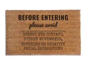 Coir doormat printed with Before Entering Please Avoid Direct Eye Contact, Sudden Movements, Coughing or Negative Facial Expressions in black house-rules lettering