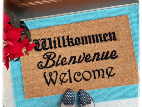 Sustainable coir welcome doormat printed with Willkommen Bienvenue Welcome in black lettering