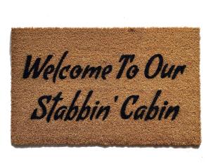 Coir doormat printed with 'Welcome To Our Stabbin Cabin' 