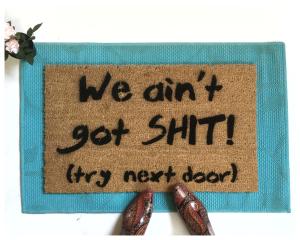 Coir doormat printed with 'We Ain't Got Shit! Try Next Door' funny welcome mat for front porch