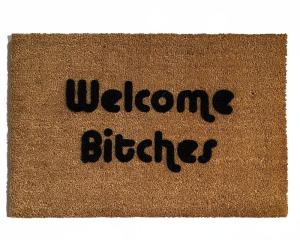 outdoor coir doormat with text "welcome bitches" on it