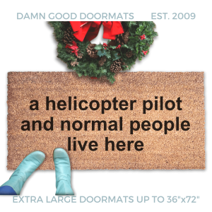 coir doormat with funny saying "a pilot and normal people live here" with a Christmas wreath and a person in Smurf blue boots