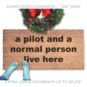 coir doormat with funny saying "a pilot and a normal person live here" with a Christmas wreath and a person in Smurf blue boots