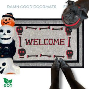 a Halloween-themed welcome mat with a skeleton and skull motif, a black pug looks up and a pair of feet in witchy boots stand on the doormat.