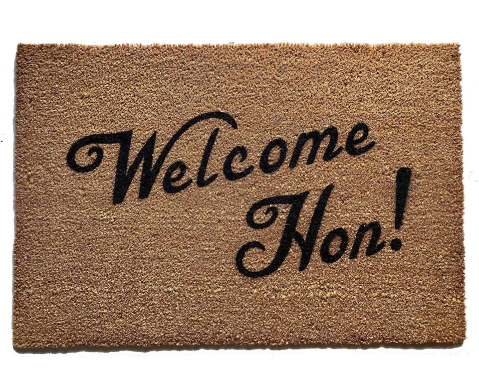 Sustainable coir doormat with "Welcome Hon" Baltimore Maryland text on a front porch