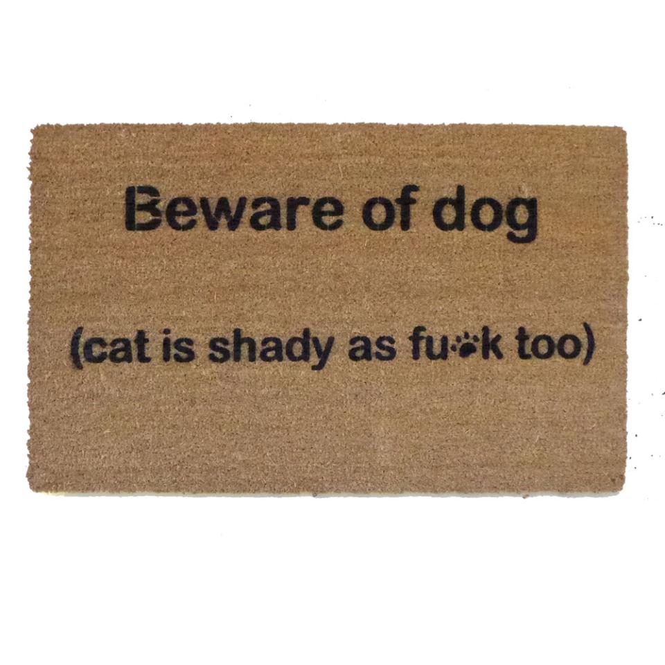 Coir doormat with "Beware of Dog, Cat is shady" text design