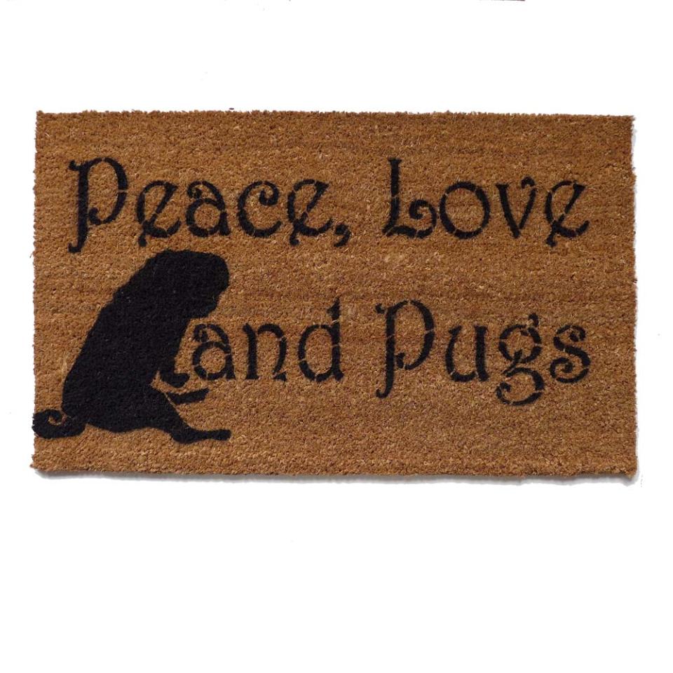 coir doormat reading "Peace, Love & Pugs" with a pug silhouette, welcome mat for dog lovers by Damn Good Doormats.