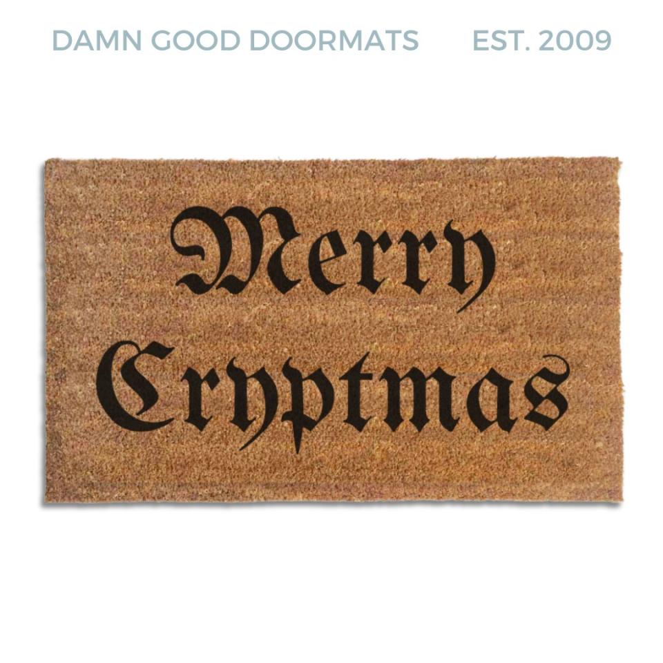 Coir doormat printed with Merry Cryptmas in black gothic blackletter