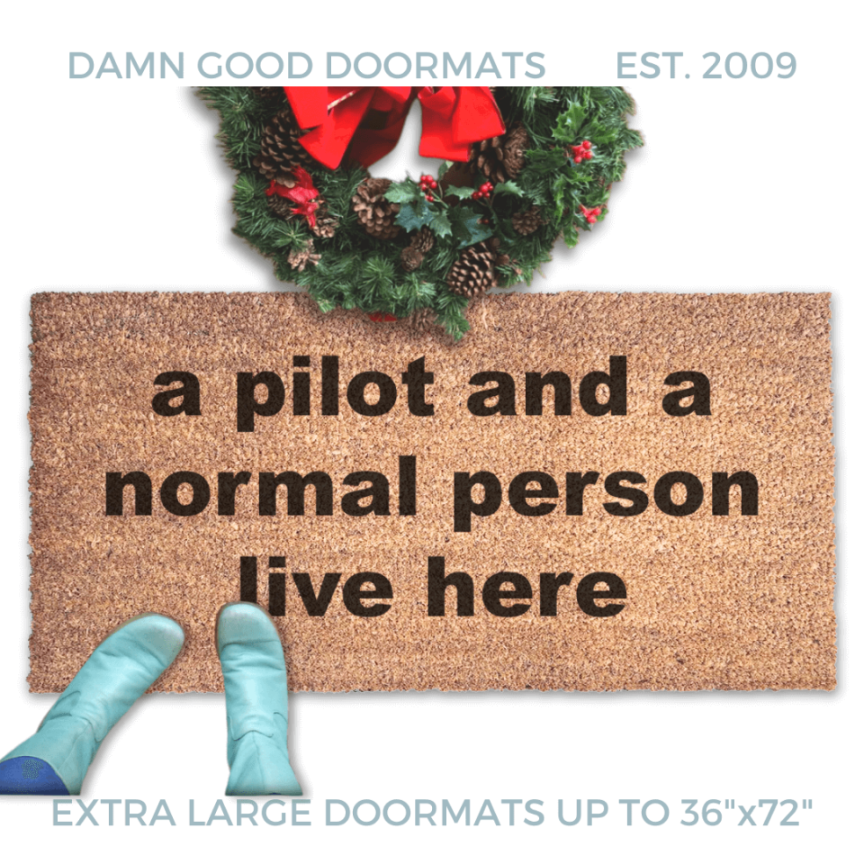 coir doormat with funny saying "a pilot and a normal person live here" with a Christmas wreath and a person in Smurf blue boots