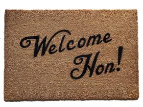 Sustainable coir doormat with "Welcome Hon" Baltimore Maryland text on a front porch