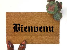 Black gothic-script "Bienvenue" coir welcome mat with ornate border, outdoor doormat