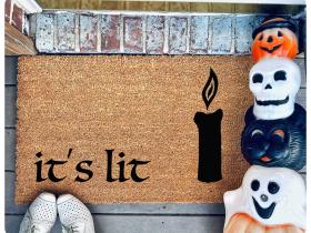 hocus pocus doormat reading it's lit with the black flame candle